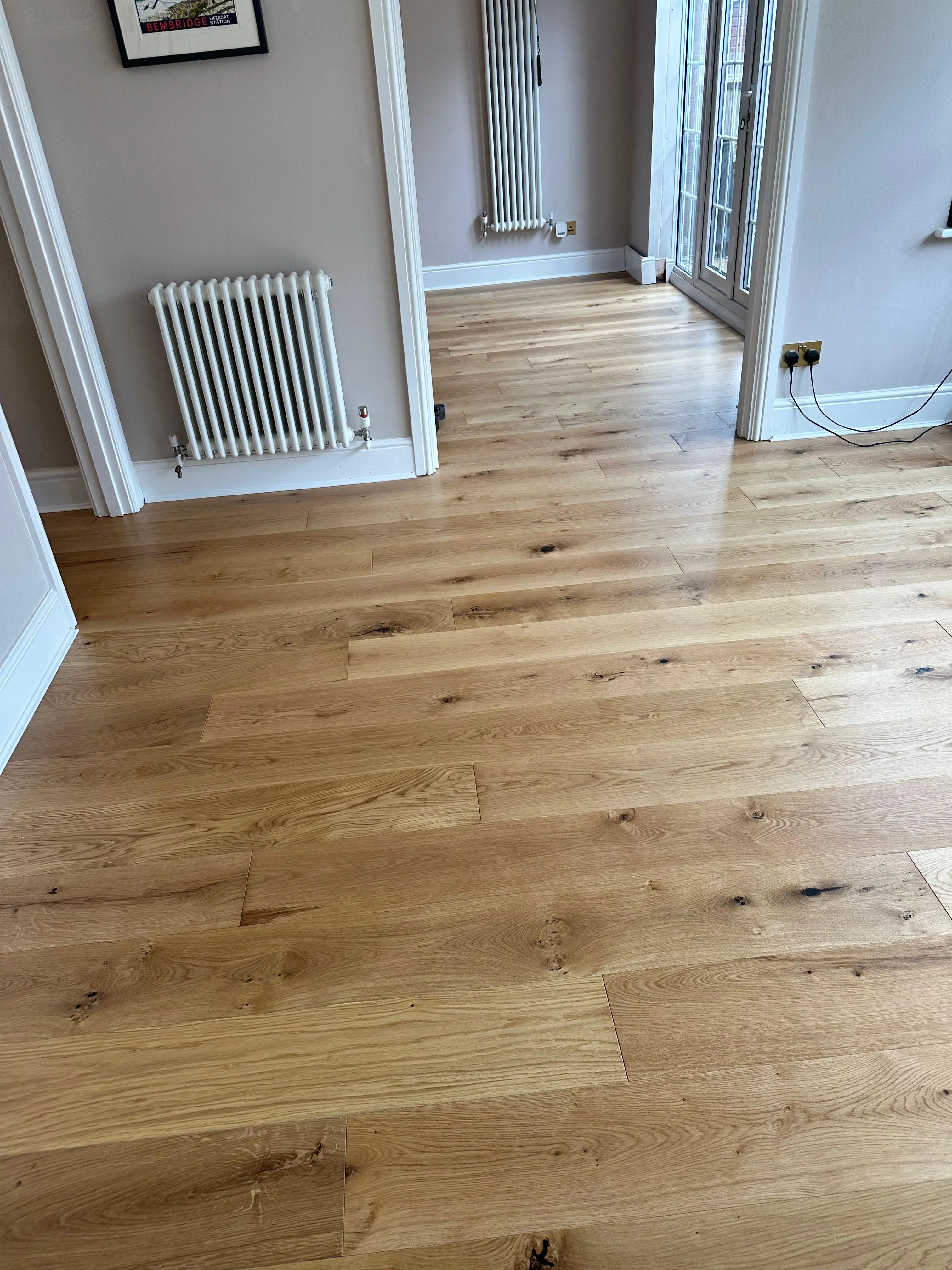 Natural engineered oak plank flooring in an open-plan dining room