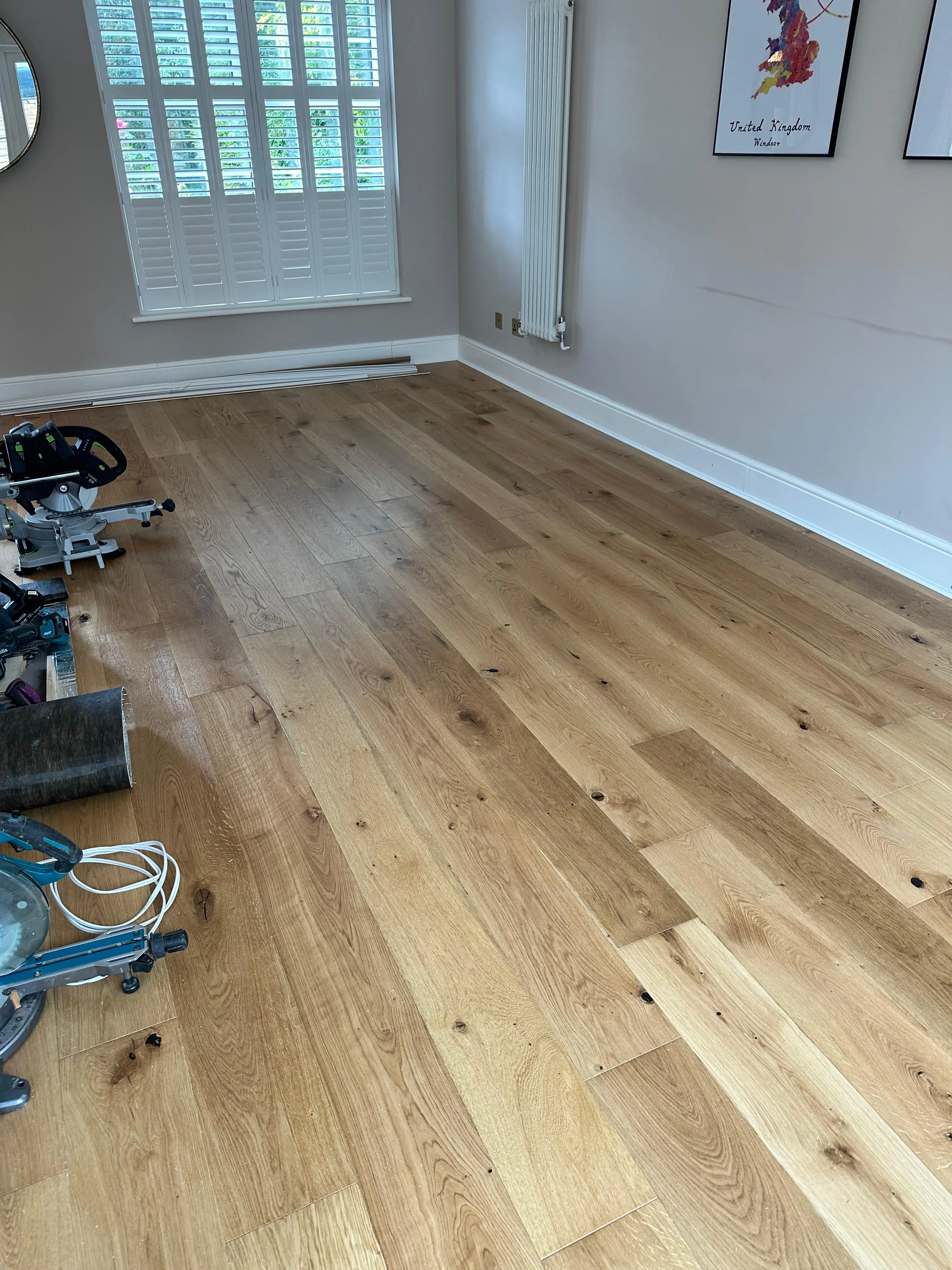 Natural engineered oak plank flooring fitted across a living room