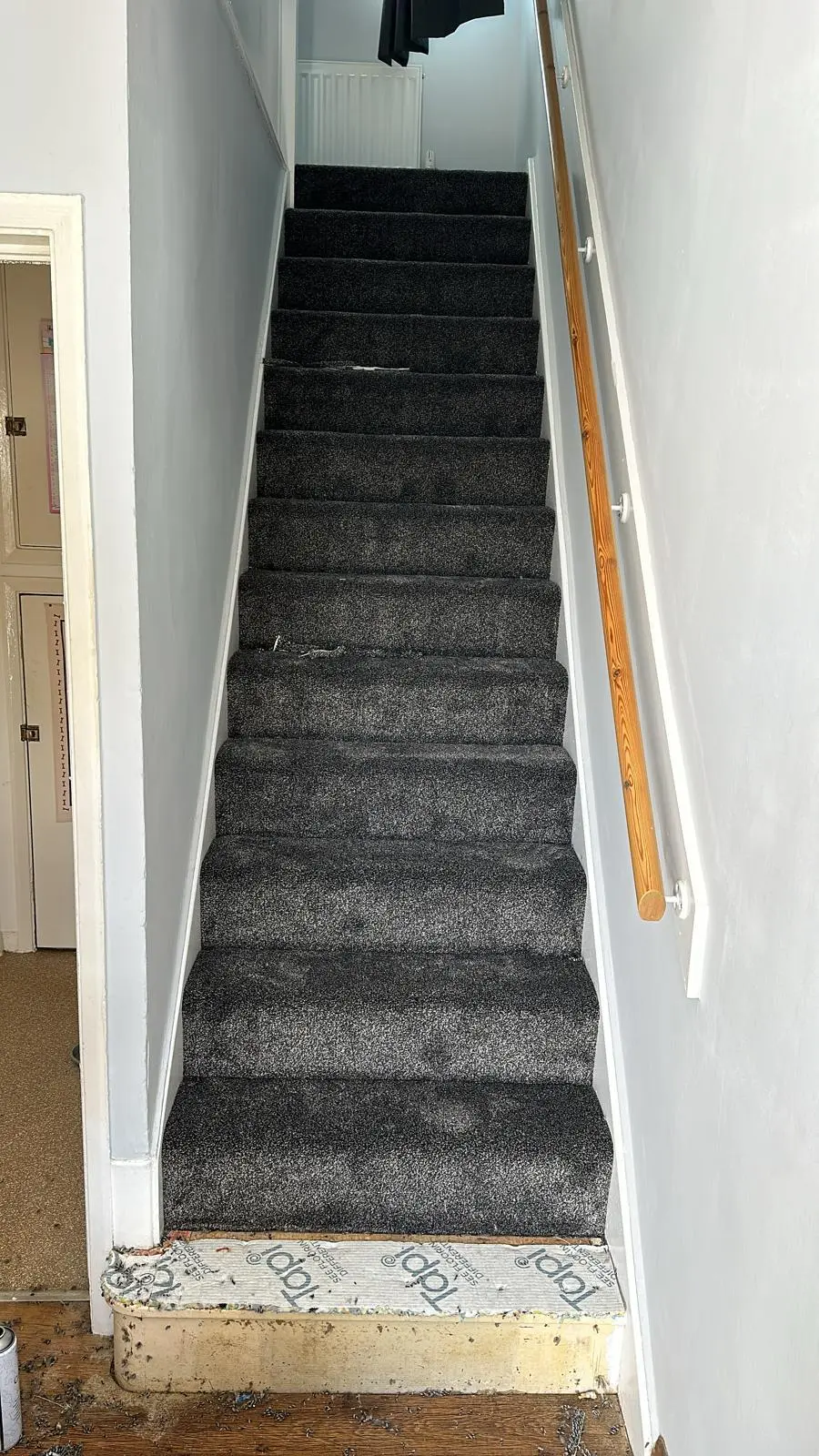Charcoal speckled carpet fitted on a straight staircase